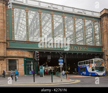 Historic central railway station entrance with double decker bus emerging from tunnel  beneath high glass façade and roof in city of Glasgow, Scotland Stock Photo