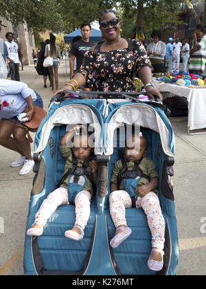 Proud mother and her ten month old twin girls head to Spike Lee's 9th Annual block party in the Bedford Stuyvesant section of Brooklyn, NY, Aug.26, 20 Stock Photo