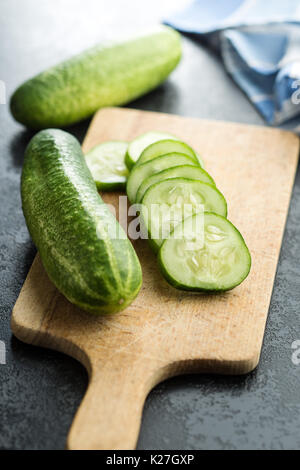 Sliced green cucumbers. Cucumbers on cutting board. Stock Photo