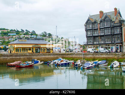 English coastal town of Dartmouth with elegant historic buildings bordering harbour with boats in calm water, Devon UK Stock Photo