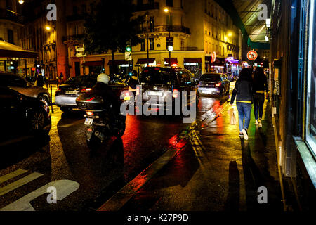 General views of colorful reflections and people on a rainy night in Paris, France on September 17, 2016. Stock Photo