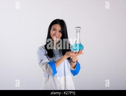 An Asian lady holds a glass bottle Stock Photo