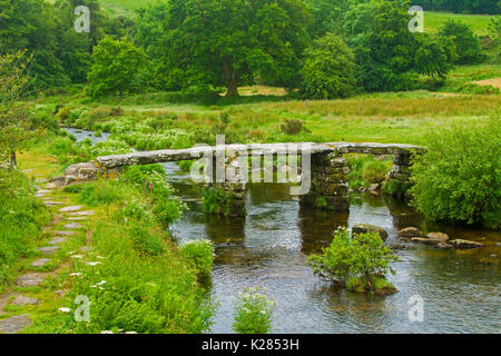 Heritage listed medieval clapper bridge over East Dart, tributary of River Dart, near village of Postbridge, Dartmoor National Park, Devon, England.
