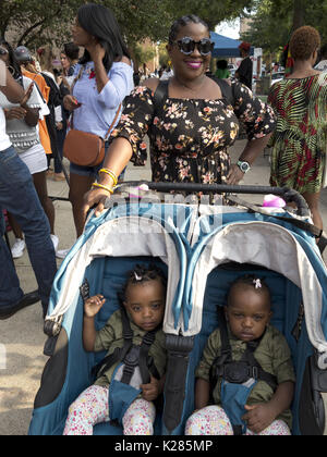 Proud mother and her ten month old twin girls head to Spike Lee's 9th Annual block party in the Bedford Stuyvesant section of Brooklyn, NY, Aug.26, 20 Stock Photo