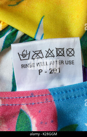 Rinse well after use label in bikini showing washing care symbols Stock ...