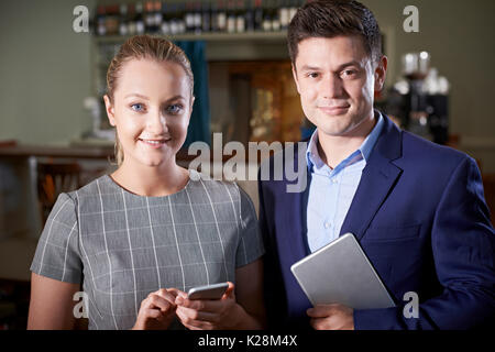 Portrait Of Owner With Waitress In Restaurant Stock Photo