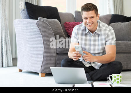 Male Freelance Worker Using Laptop At Home Stock Photo