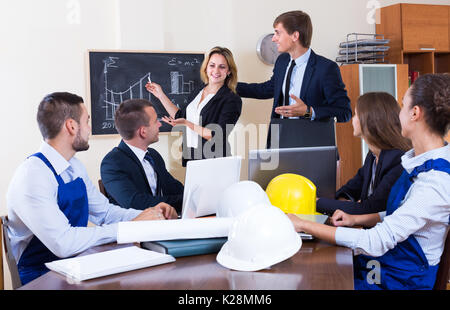 Team of architects and engineers at the working meeting in office. Selective focus Stock Photo