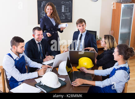 Brainstorming team of architects discussing business project indoors Stock Photo