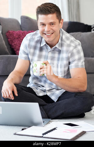 Male Freelance Worker Using Laptop At Home Stock Photo