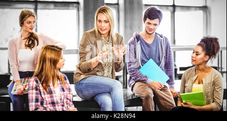 Happy students talking with their teacher Stock Photo