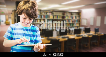 Composite image of smiling boy using digital tablet Stock Photo