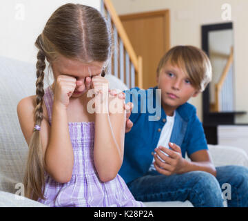 Offended children having serious quarrel at home. Focus on girl Stock Photo