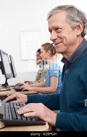 Mature Man Attending Computer Class Stock Photo