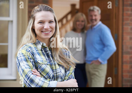 Portrait Of Young Woman With Parents At Home Stock Photo