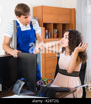 Terrified young woman having problems with internet connection at home Stock Photo
