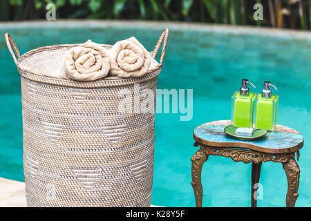 Bottle of shower gel and wicker basket with shells on sink in bathroom  Stock Photo - Alamy