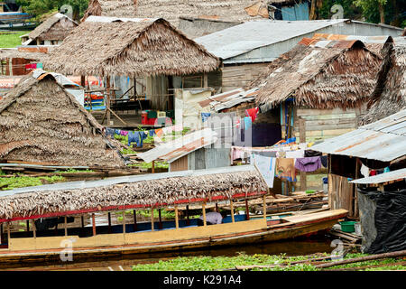 Floating houses in Iquitos, Peru. The traditional thatched roofed houses found in the poorer areas of the city. Stock Photo