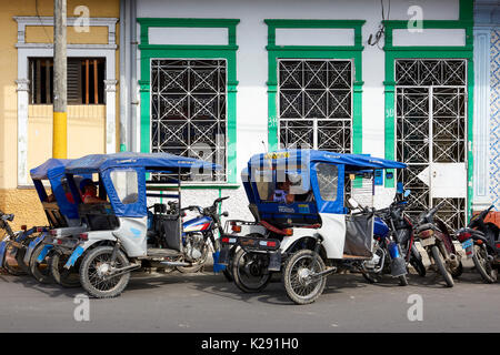 Mototaxi drivers taking a break in the shade in Iquitos, Peru. Stock Photo