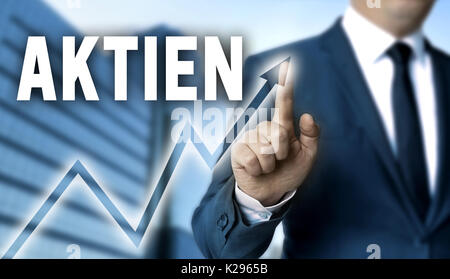 Aktien (in german shares) touchscreen is operated by businessman. Stock Photo