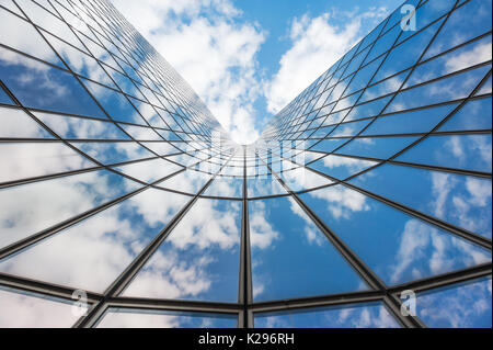 Blue sky and white clouds reflecting in a  glass building