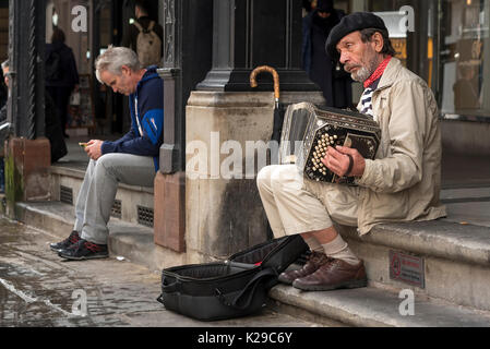 Busker playing accordion wearing beret. Chester Rows. Stock Photo
