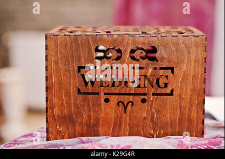 Close-up photo of a wooden brown box with inscription "wedding". Stock Photo