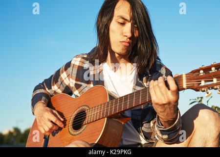 Handsome Guitar Player Practicing Outdoors Stock Photo