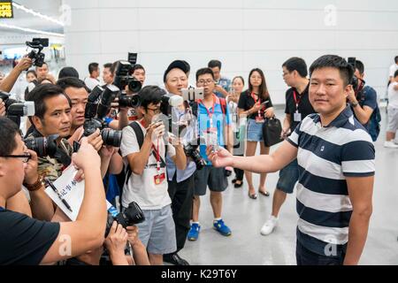 Chongqing, China. 29th Aug, 2017. A passenger is interviewed at the T3A terminal of the Jiangbei Airport in Chongqing, southwest China, Aug. 29, 2017. The T3A terminal and the third runway of the airport are put into operation on Tuesday. Credit: Liu Chan/Xinhua/Alamy Live News Stock Photo