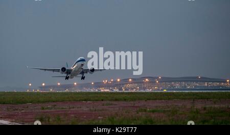 Chongqing, China. 29th Aug, 2017. An aircraft takes off from the third runway of the Jiangbei Airport in Chongqing, southwest China, Aug. 29, 2017. The T3A terminal and the third runway of the airport are put into operation on Tuesday. Credit: Liu Chan/Xinhua/Alamy Live News Stock Photo