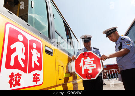 Chongqing, China. 29th Aug, 2017. Policemen check a school bus in Chongqing, southwest China, Aug. 29, 2017. Most of Chinese students is going to receive their new semester in September. Credit: Chen Shichuan/Xinhua/Alamy Live News Stock Photo