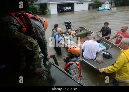 Texas, USA. 28th Aug, 2017. Texas National Guard soldiers and volunteer fire and rescue personnel evacuate residents and their pets trapped by flooding in the aftermath of Hurricane Harvey August 28, 2017 in Cypress, Texas. Credit: Planetpix/Alamy Live News Stock Photo