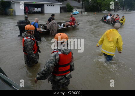 Texas, USA. 28th Aug, 2017. Texas National Guard soldiers and volunteer fire and rescue personnel evacuate residents and their pets trapped by flooding in the aftermath of Hurricane Harvey August 28, 2017 in Cypress, Texas. Credit: Planetpix/Alamy Live News Stock Photo