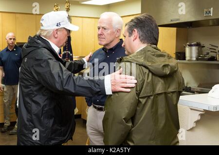 U.S. President Donald Trump reassures Senators John Cornyn, left, and Ted Cruz during a visit to view damage from Hurricane Harvey August 29, 2017 in Corpus Christi, Texas. Stock Photo