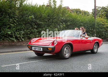 1973 70s red Jensen-Healey 1973cc petrol sportscar. British two-seater convertible sports car at the Ormskirk MotorFest Vintage, classic cars from all eras of motoring in the town centre streets and in Coronation Park for people to admire. Stock Photo