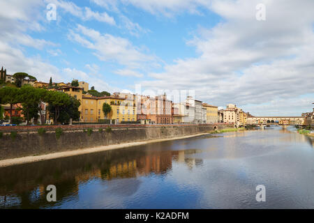 Quay of the Arno River and Ponte Vecchio Bridge in Florence, Italy on a summer sunny day Stock Photo