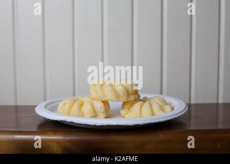 Close up of three sweet cruller donuts on a plate Stock Photo