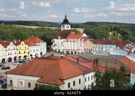 Holy Trinity Church (Kostel Nejsvětější Trojice) and the surrounding houses in Husovo Square in Nové Město nad Metují, Czech Republic. The aerial view of the town main square is pictured from the tower of a local chateau. Stock Photo