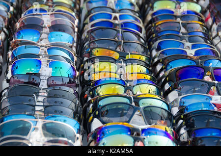 Sunglasses with multicoloured lenses in rows Stock Photo