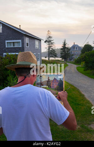 USA Maine ME Monhegan Island an artist is painting a home a gravel road at the end of the day Stock Photo