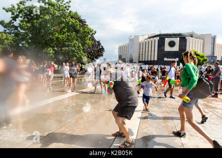 Sofia, Bulgaria - 8 July 2017: Children and adults participate in a fight with water guns and other water spray equipment in the center of Sofia. Stock Photo