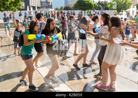 Sofia, Bulgaria - 8 July 2017: Children and adults participate in a fight with water guns and other water spray equipment in the center of Sofia. Stock Photo