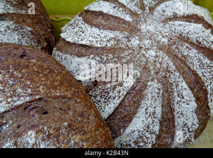 Dark brown whole grain bread loaves, closed up for background, texture Stock Photo