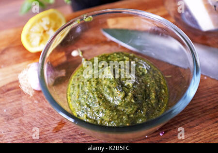 Making home made Italian  pesto sauce with basil parmesan cheese garlic and pine nuts with olive oil Stock Photo