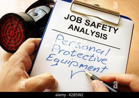 Man is writing words Personal protective equipment (PPE). Stock Photo