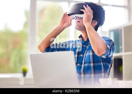 Talented Designer Using VR Headset Stock Photo