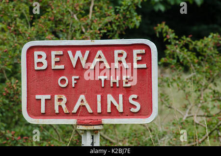 Old fashioned cast iron Beware of Trains sign Stock Photo