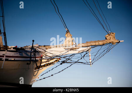 Reflection of boat hull, ropes, chains and furled sails, Northeast Harbor, Maine, USA, August 2010. Stock Photo