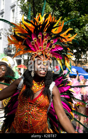 Notting Hill Carnival August 28th 2017. West London, England.Happy female dancer with feathered head dress Stock Photo