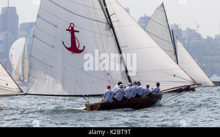 Sloop racing in Sydney Harbour with RIB nearby, New South Wales, Australia, October 2012. All non-editorial uses must be cleared individually. Stock Photo